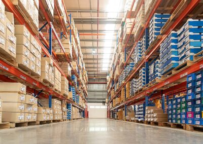 Seismic anchorage design for warehouse racking systems, featuring high-bay pallet storage supported by anchored steel frames in a large distribution facility. This image highlights Vector Engineers’ expertise in designing seismic anchorage for storage racks and equipment, helping ensure code compliance, structural stability, and safety in high-load industrial environments.